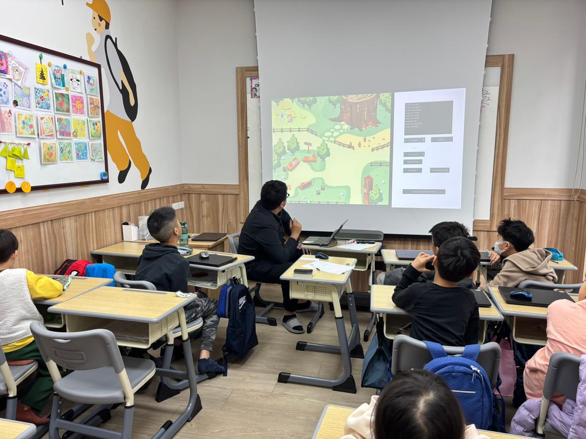 Classroom teaching setting with students learning how to code